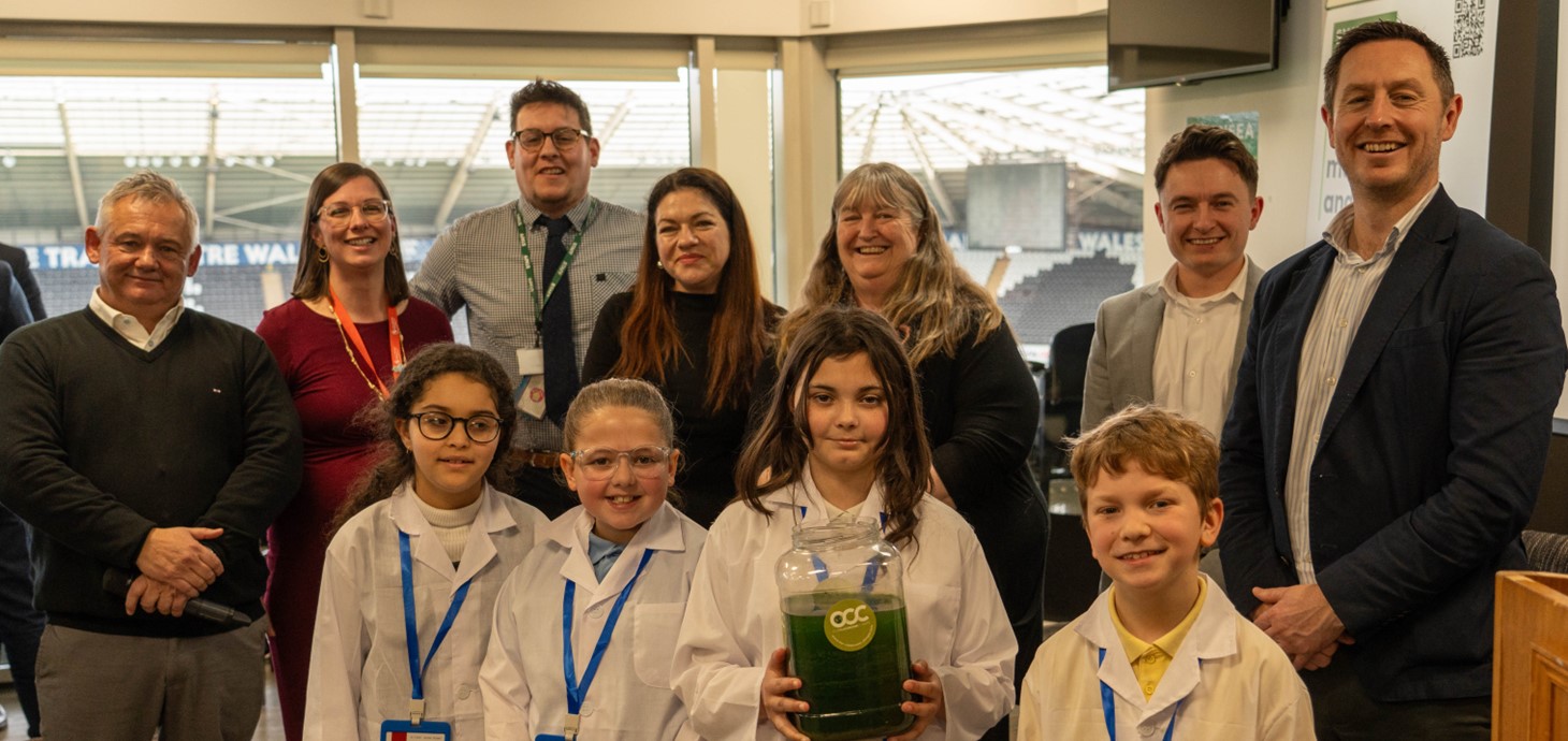 Students, organisers and attendees at the Swansea Schools & Climate Education event. A student is holding one of the liquid trees.
